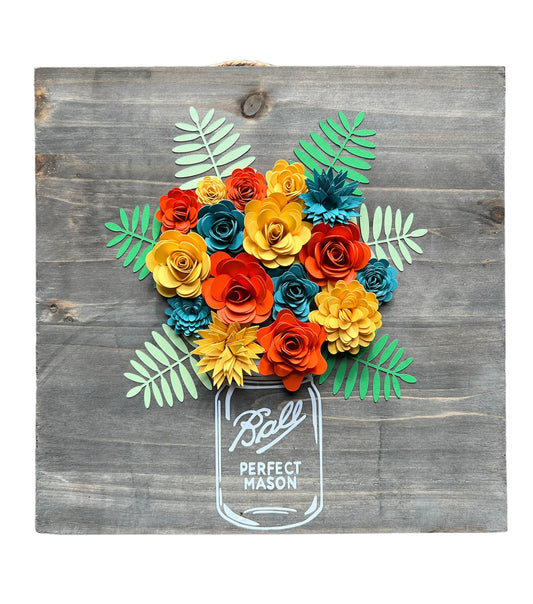 bouquet made of paper flowers in oranges, yellows and blues